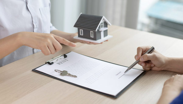 Tenant signing a rental agreement with landlord