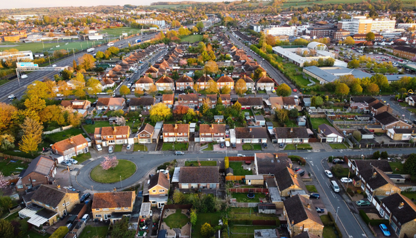 An aerial view of a neighborhood with similar looking houses and well-planned roads, creating an ideal place to live